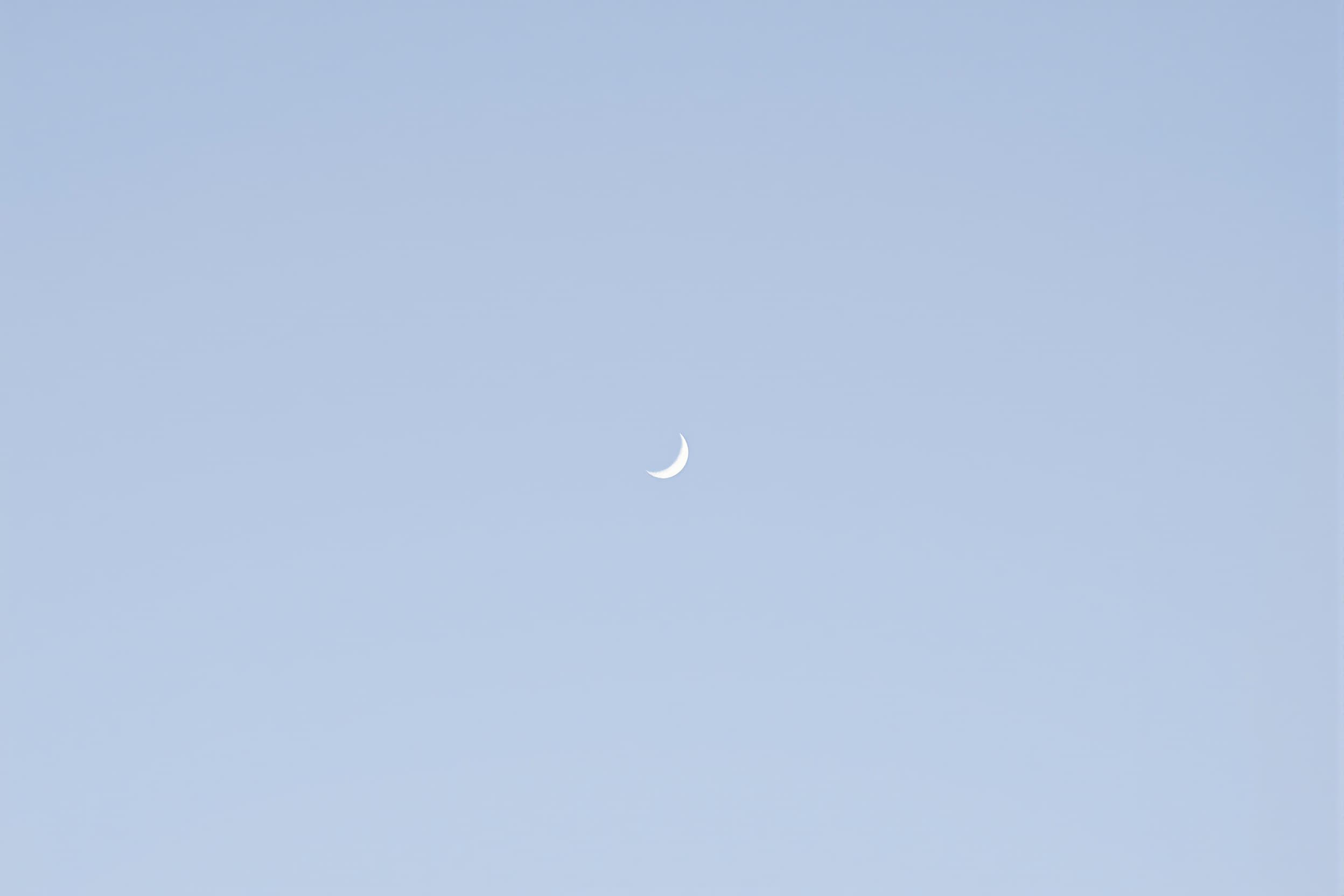 Serene Crescent Moon in Clear Blue Sky