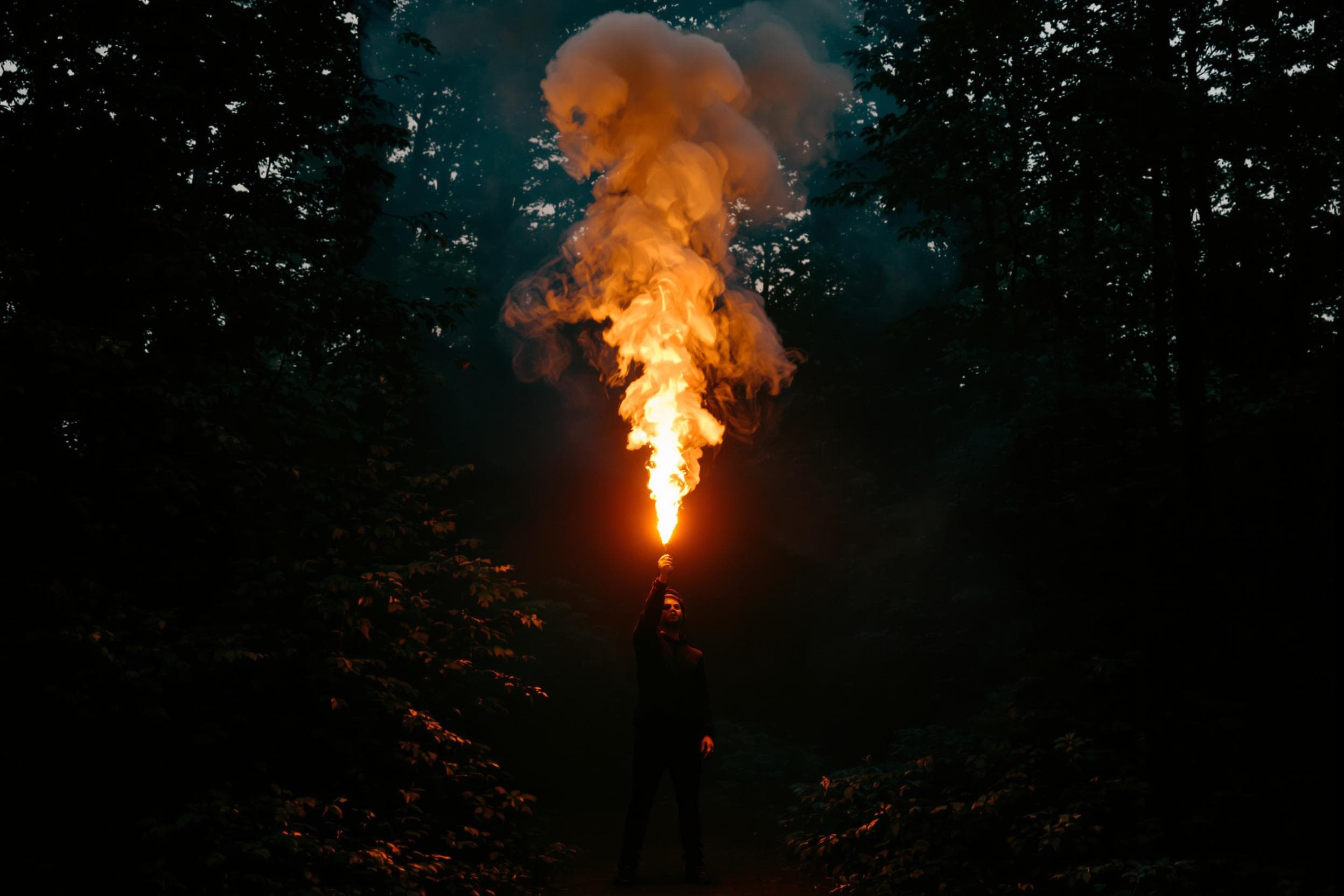 Enigmatic Explorer in Fiery Forest