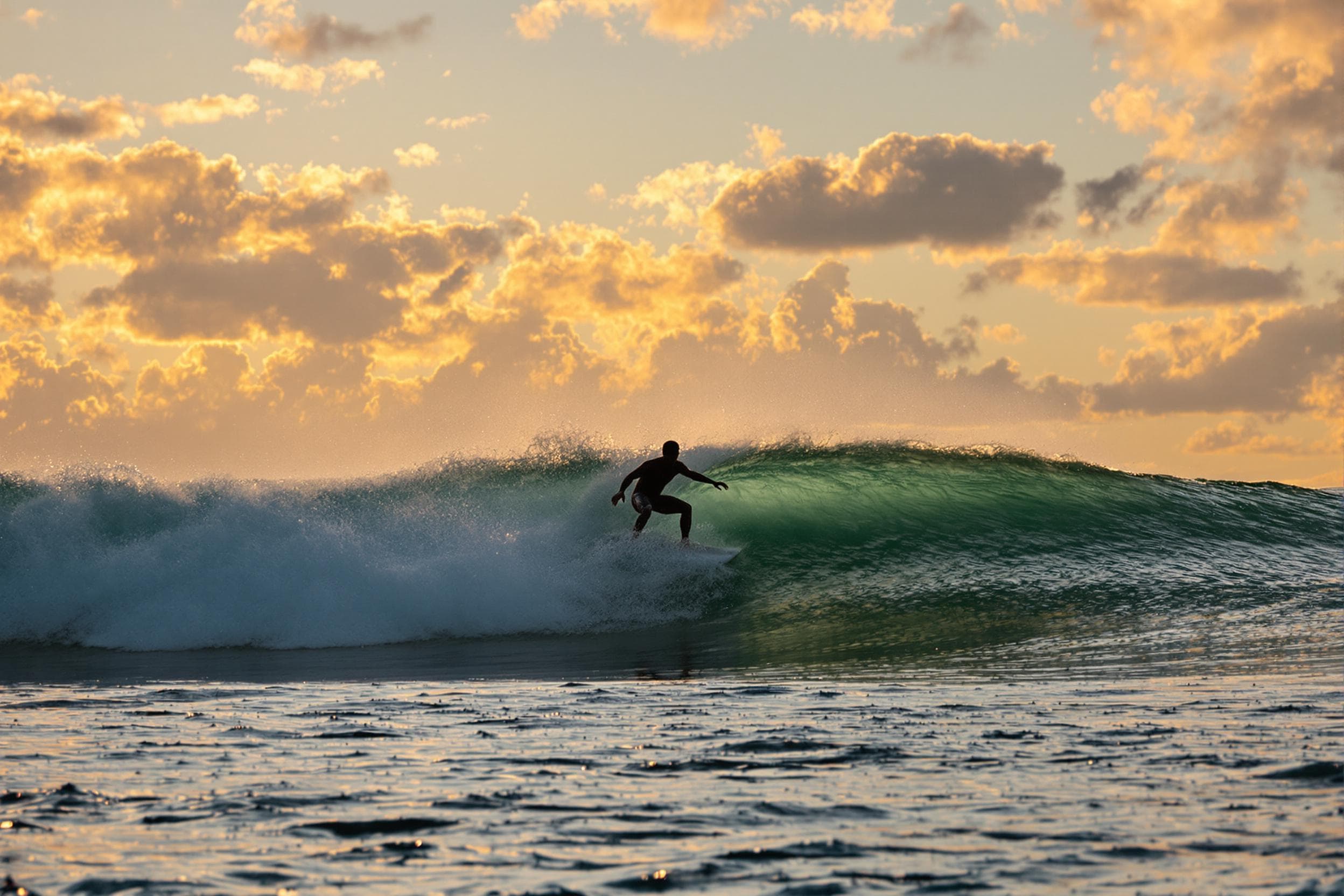 Surfer at Sunset: A Moment of Freedom
