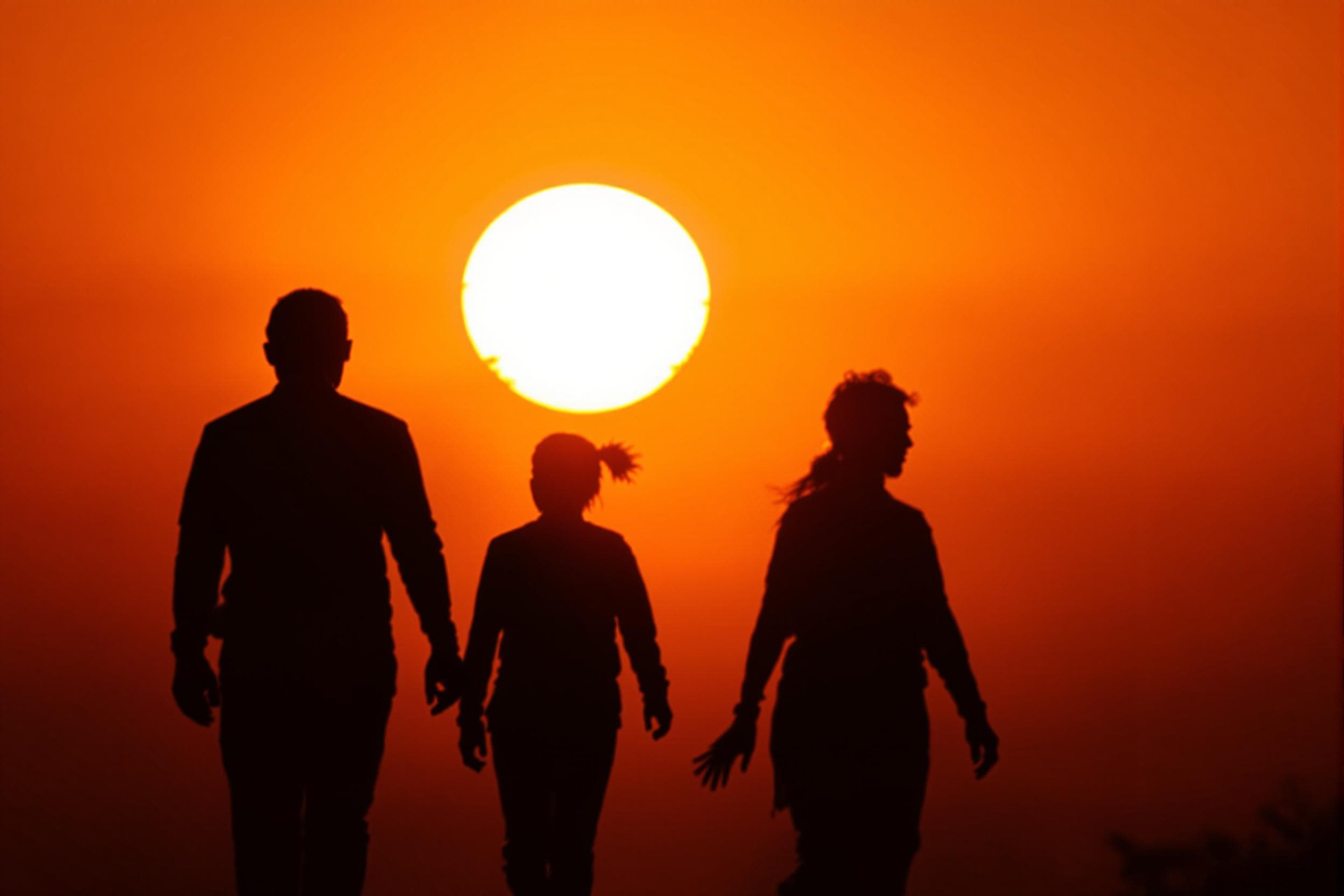Silhouetted Figures at Vibrant Sunset