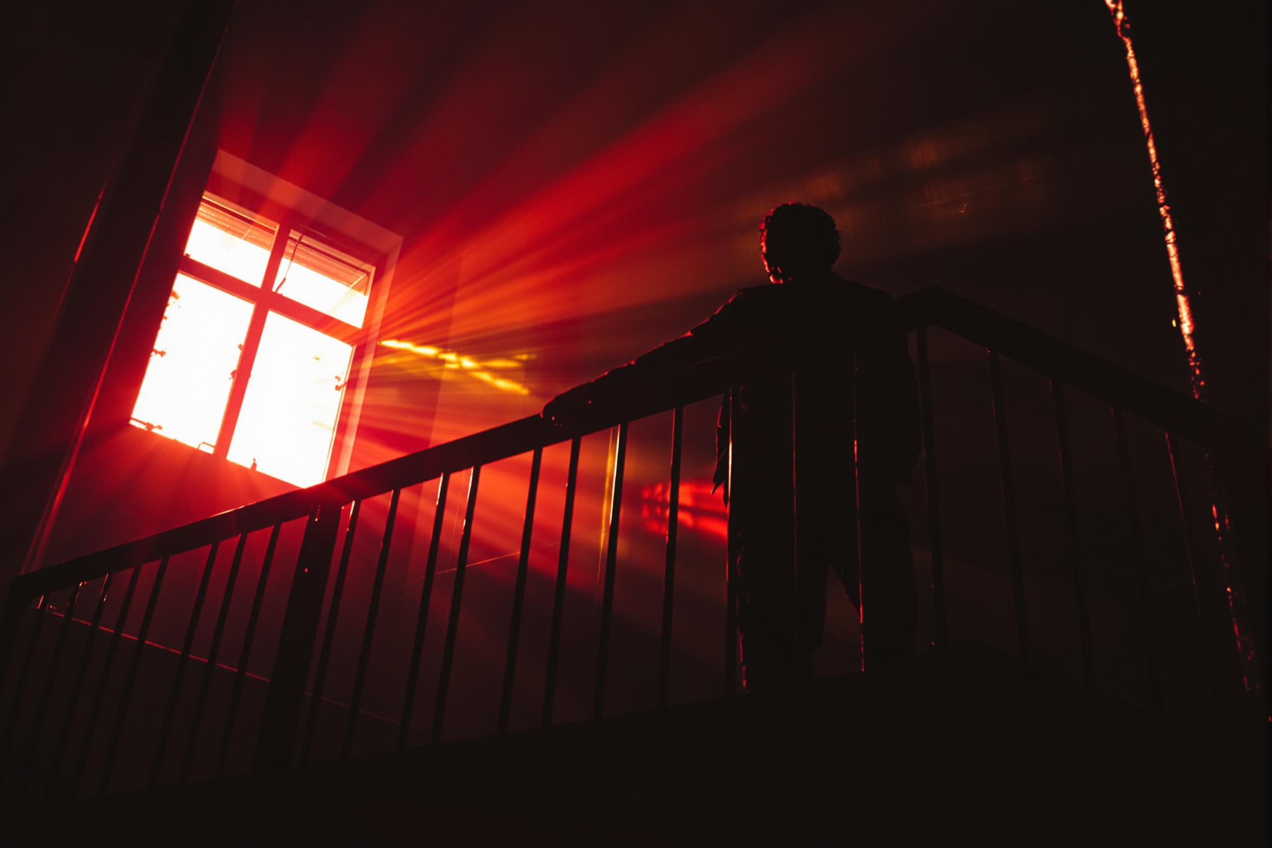 Introspective Silhouette on a Balcony