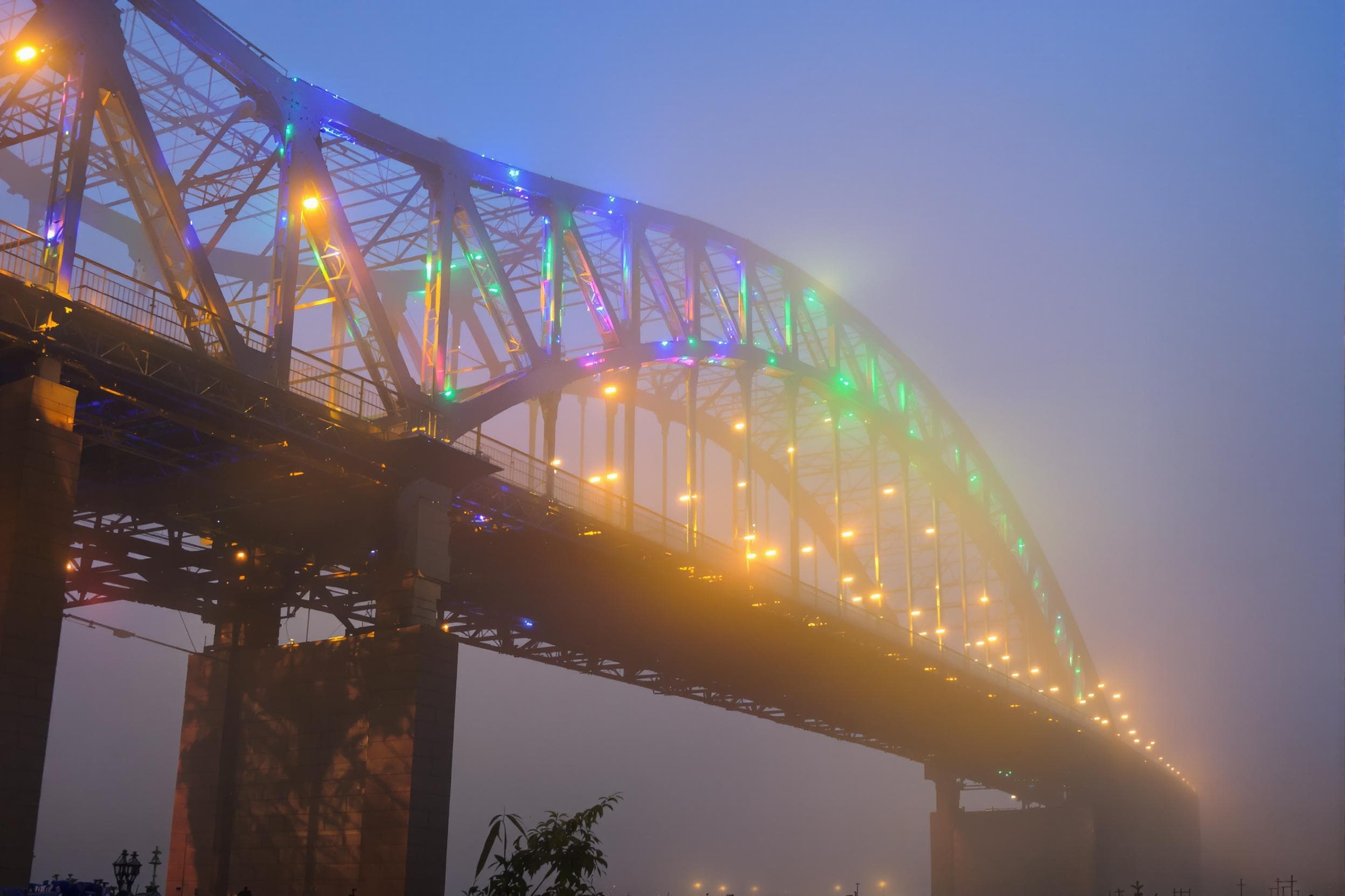 Foggy Bridge with Vibrant Lights
