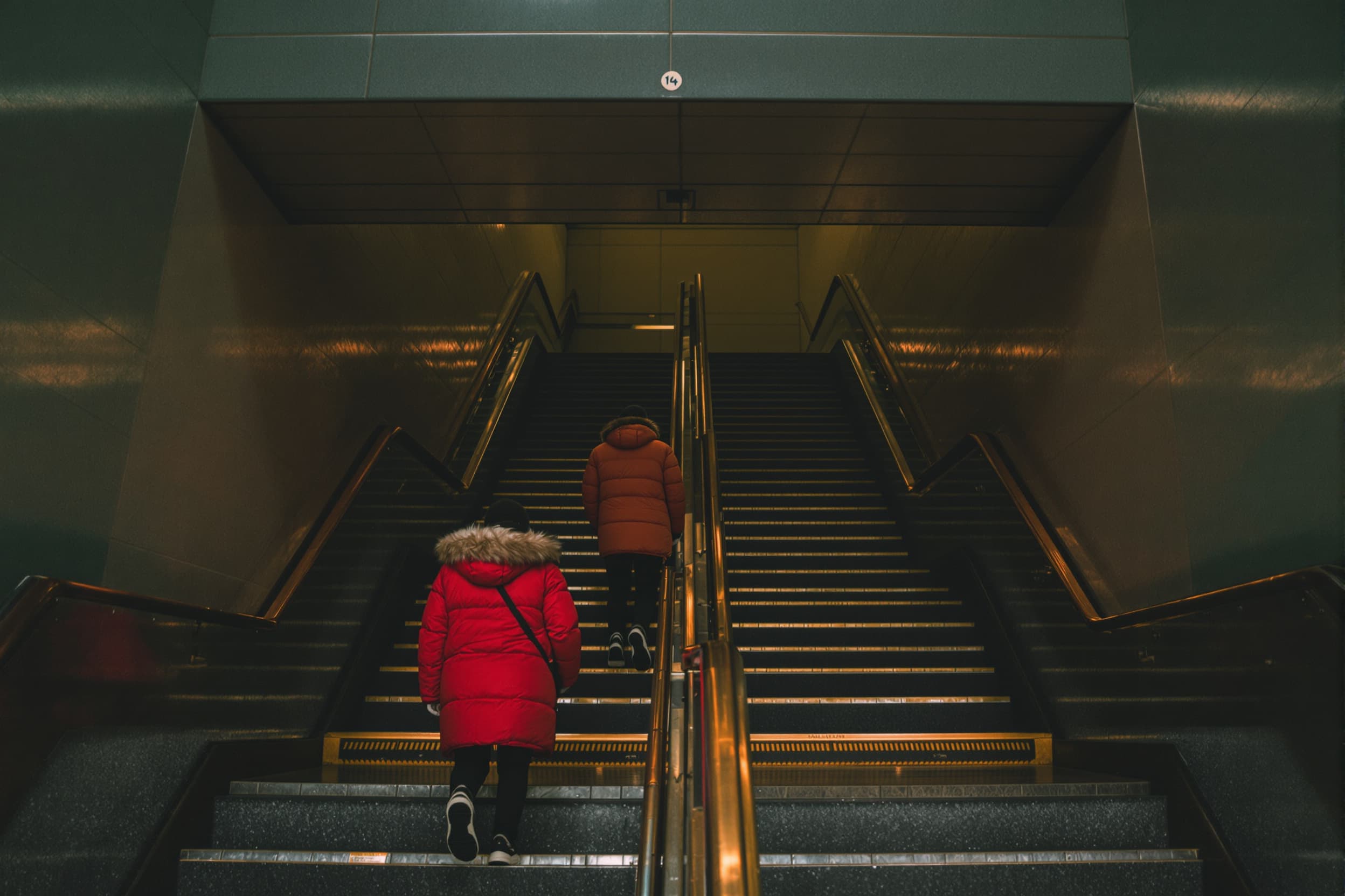 Urban Subway Descent in Vibrant Winter Gear