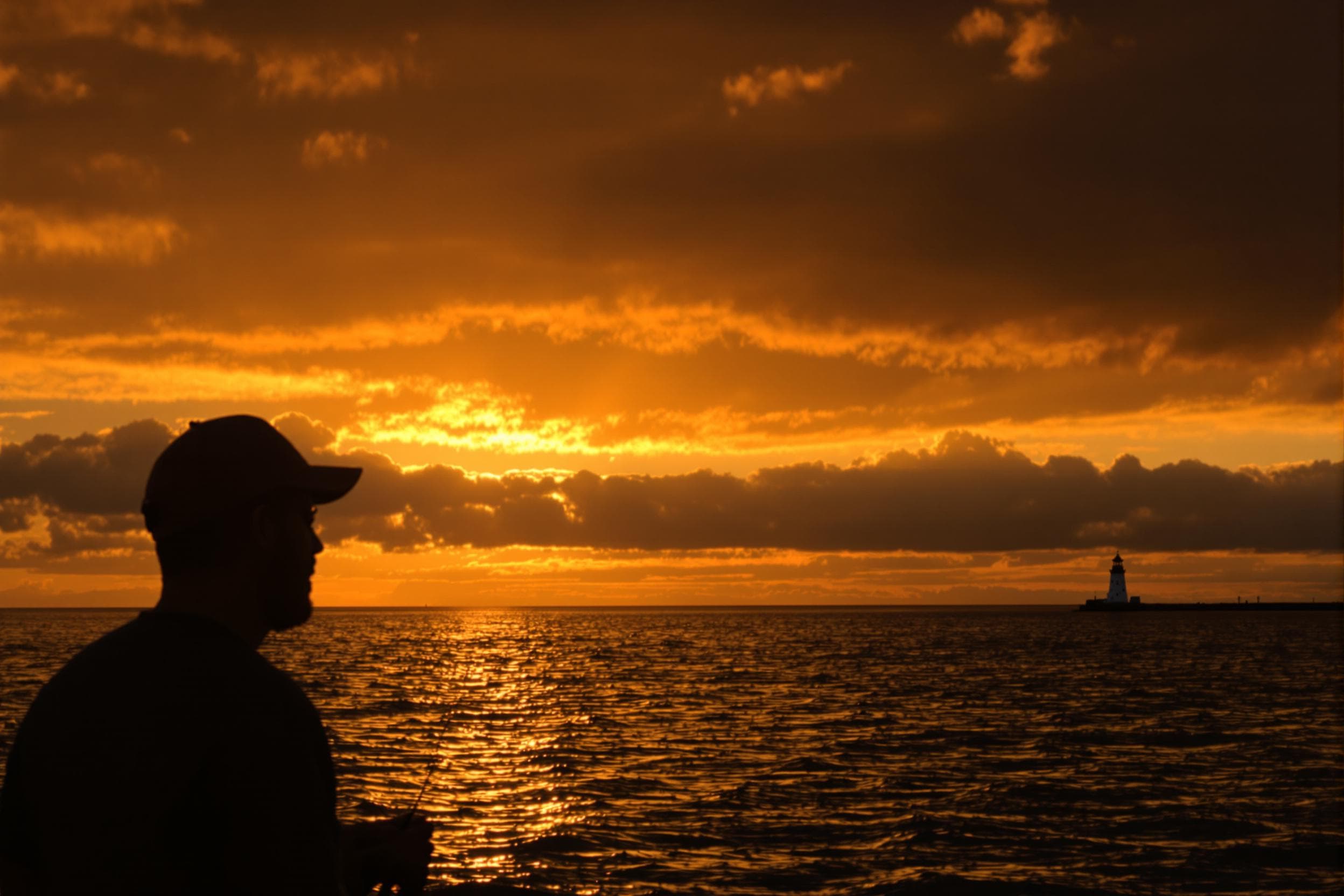 Fisherman at Sunset with Lighthouse
