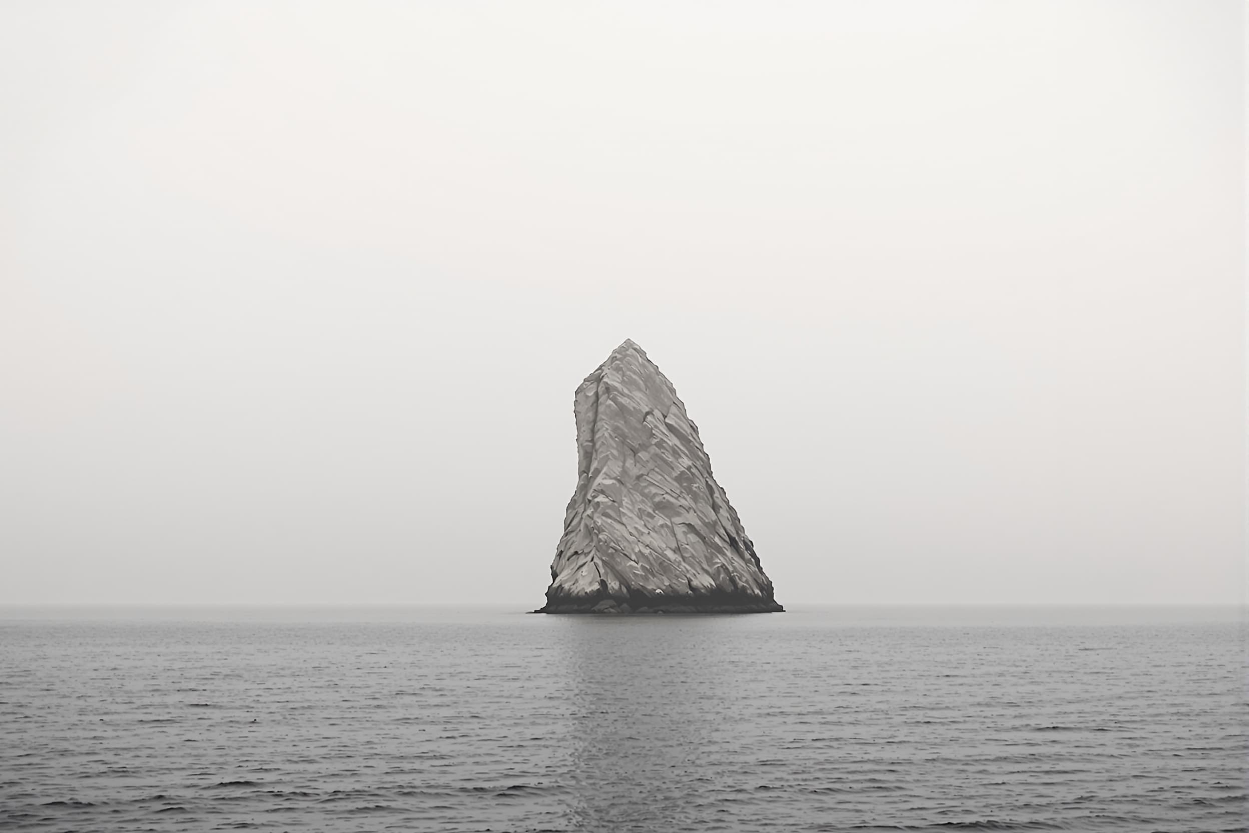 Solitary Rock Formation on Calm Sea
